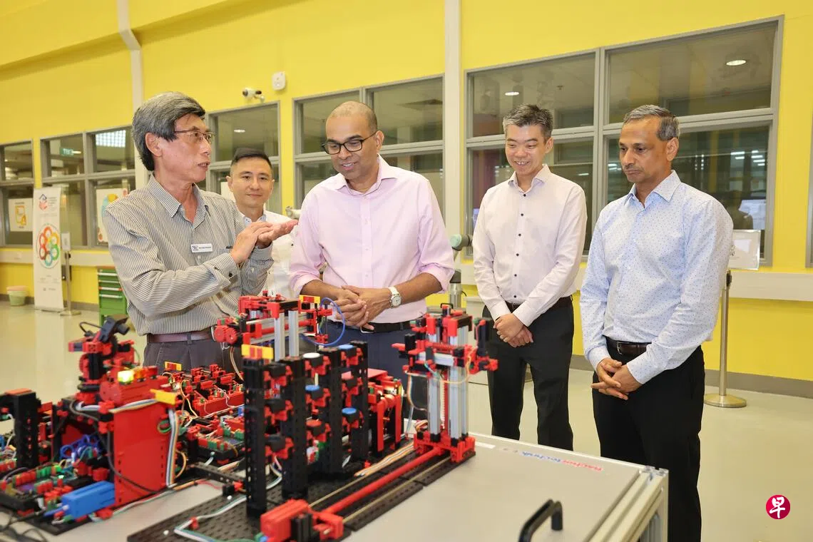 Mr Russel Chan, Dr Janil Puthucheary, and Mr Ravinder Singh in front of the NYP360 event backdrop