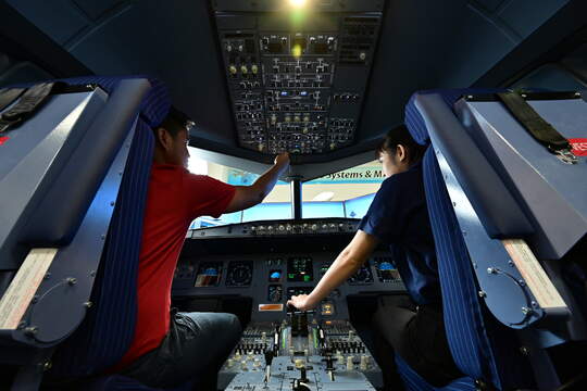 Two men doing an airplane simulation